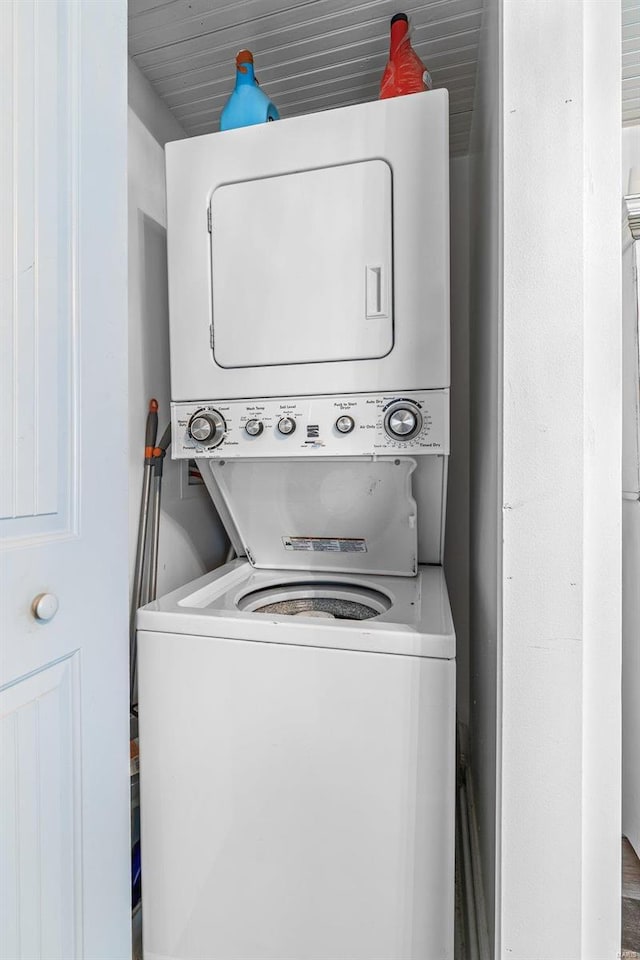 laundry room featuring stacked washer / dryer and laundry area