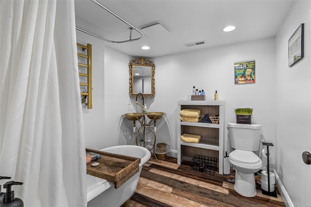 full bathroom with toilet, recessed lighting, wood finished floors, visible vents, and baseboards