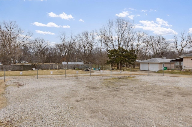 view of yard featuring a garage and fence