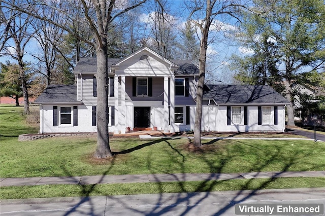 neoclassical / greek revival house with brick siding and a front yard