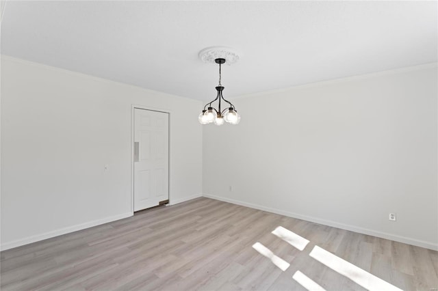 unfurnished room with baseboards, crown molding, light wood finished floors, and an inviting chandelier