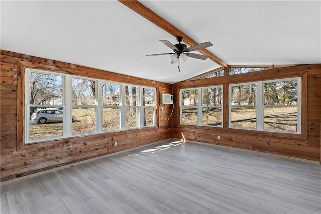 unfurnished sunroom featuring lofted ceiling with beams, ceiling fan, and a wall mounted air conditioner