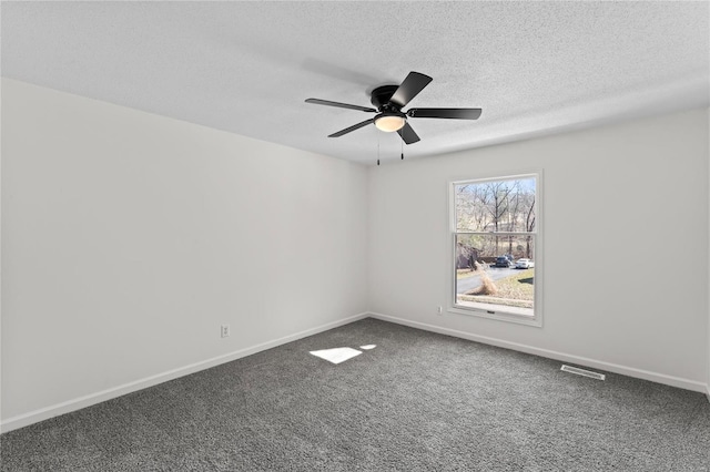 empty room featuring ceiling fan, a textured ceiling, baseboards, and carpet flooring