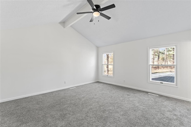 carpeted empty room featuring lofted ceiling with beams, a textured ceiling, a ceiling fan, visible vents, and baseboards