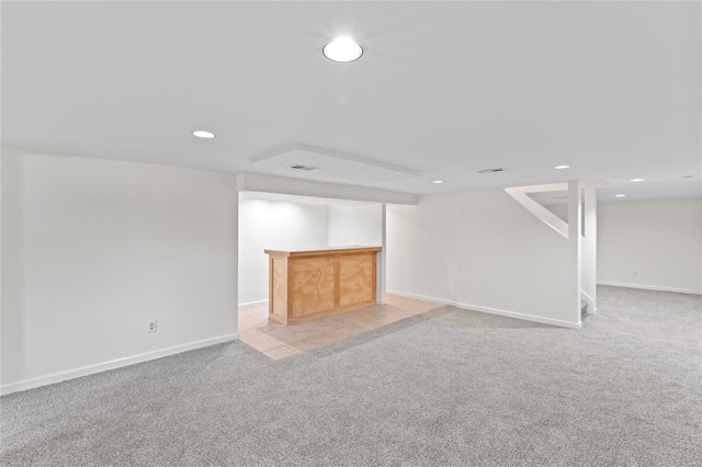 finished basement with recessed lighting, light carpet, visible vents, and baseboards