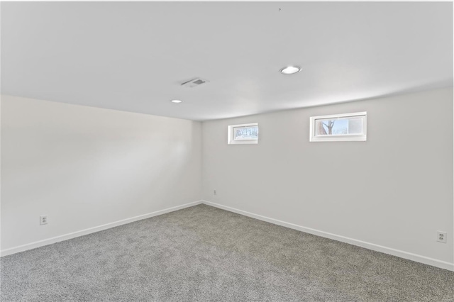 interior space with carpet flooring, visible vents, and baseboards