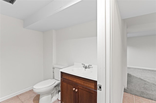 bathroom featuring tile patterned flooring, baseboards, vanity, and toilet