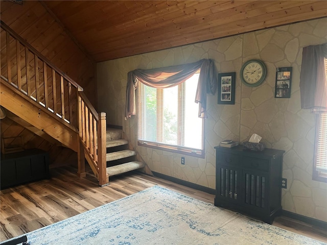 stairs with lofted ceiling, wooden ceiling, and wood finished floors