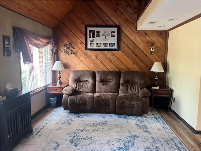 living area featuring vaulted ceiling, wooden ceiling, wood walls, and wood finished floors