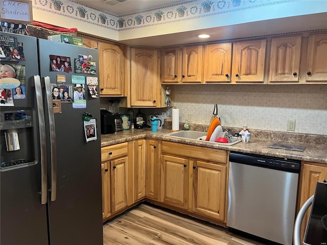 kitchen with stainless steel appliances and light wood-style floors