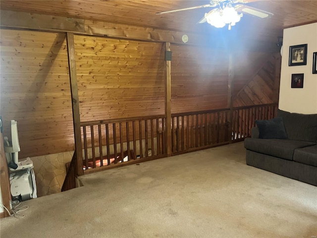 living room with vaulted ceiling, carpet floors, wooden ceiling, and wooden walls