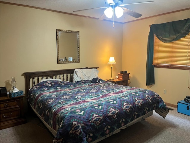 bedroom with ceiling fan, carpet, baseboards, and crown molding