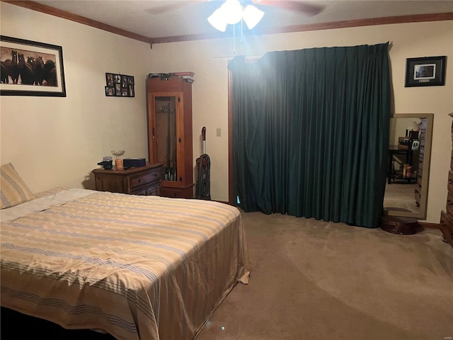 carpeted bedroom with ornamental molding and ceiling fan