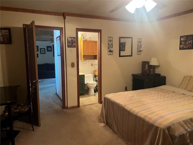 bedroom featuring connected bathroom and light colored carpet