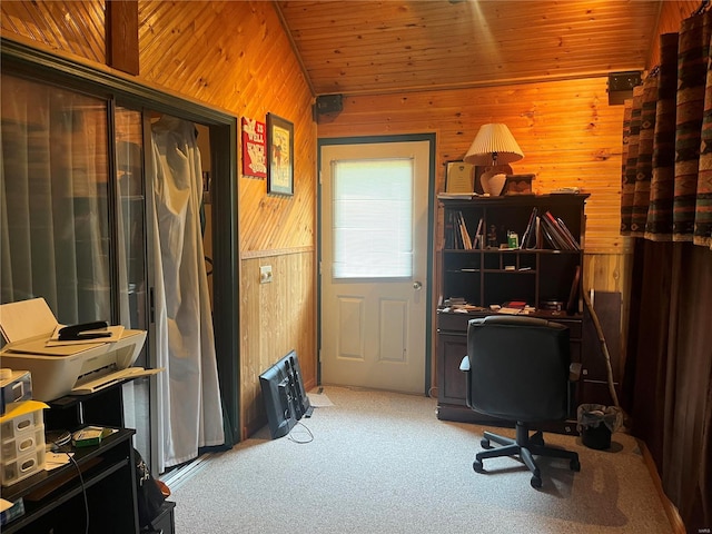 carpeted home office with lofted ceiling, wooden ceiling, and wooden walls