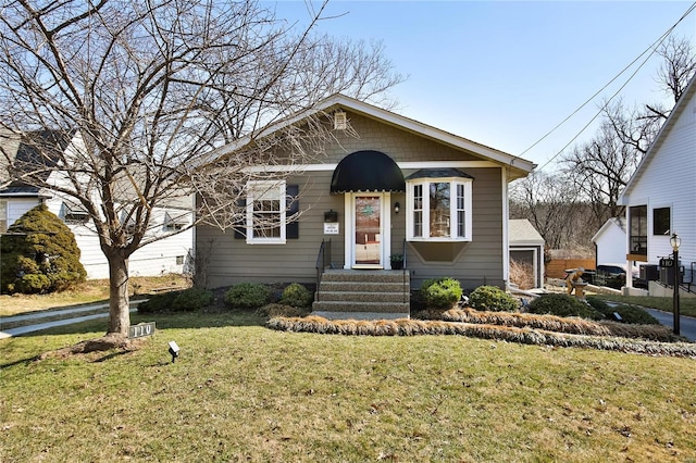 bungalow-style house featuring a front yard