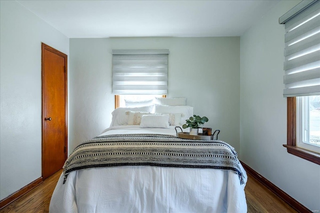 bedroom featuring baseboards and wood finished floors