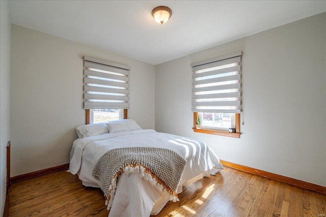 bedroom featuring baseboards and wood finished floors