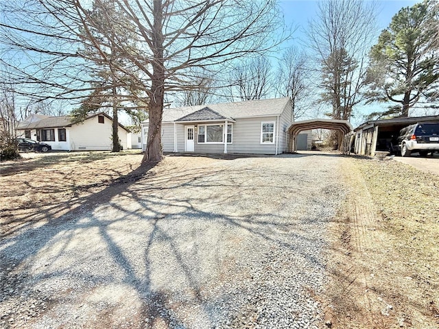 view of front facade featuring gravel driveway and a detached carport