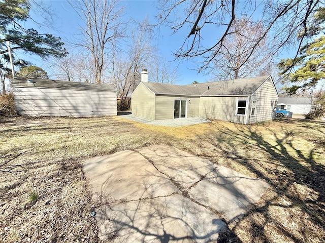 rear view of property featuring a chimney