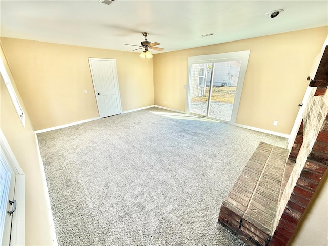 interior space featuring carpet floors, visible vents, ceiling fan, and baseboards