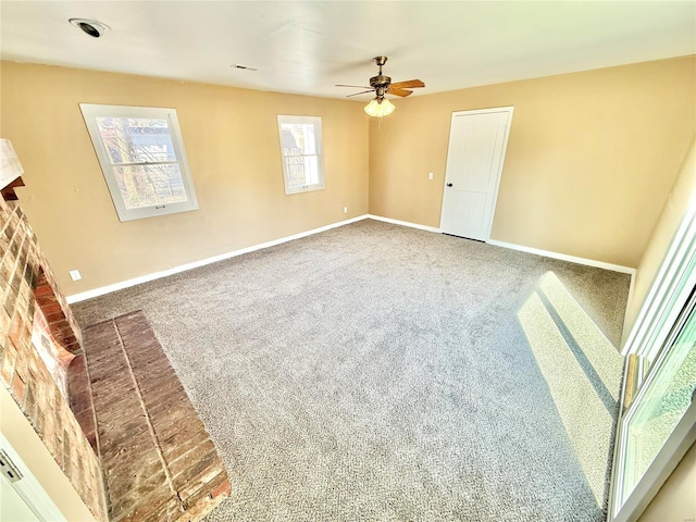 interior space with carpet floors, ceiling fan, and baseboards