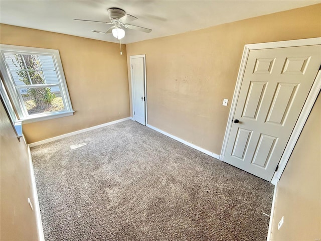 unfurnished bedroom featuring carpet, baseboards, and ceiling fan