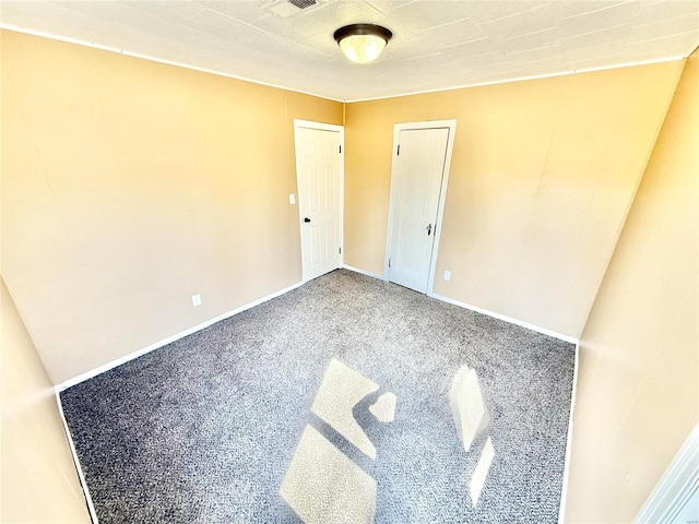 unfurnished bedroom featuring carpet floors and baseboards