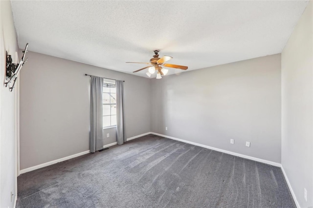 carpeted empty room with a textured ceiling, visible vents, a ceiling fan, and baseboards