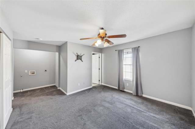 carpeted empty room with a textured ceiling, baseboards, and a ceiling fan