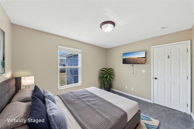 bedroom featuring carpet and baseboards