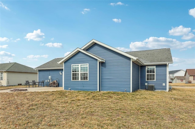 rear view of house with a patio area, a yard, and central AC unit