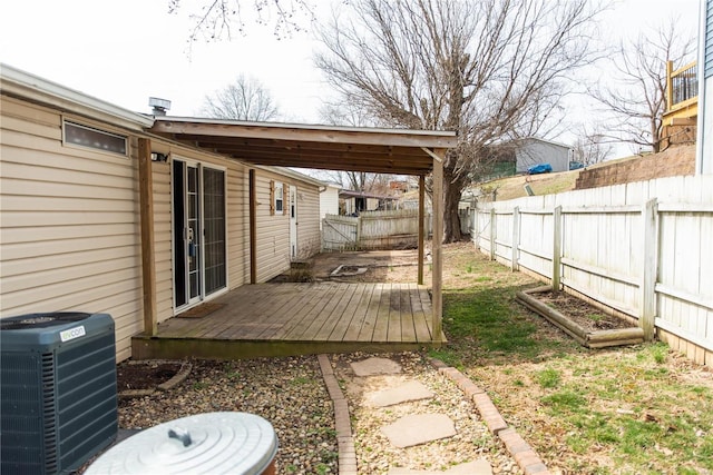 view of yard with a deck, central AC, and a fenced backyard