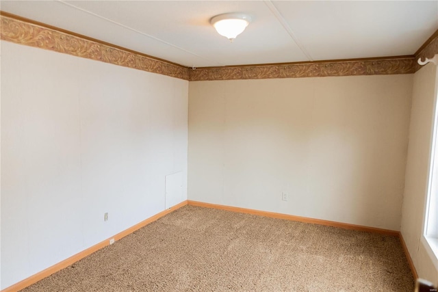 carpeted spare room with baseboards