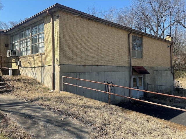 view of home's exterior featuring cooling unit and brick siding