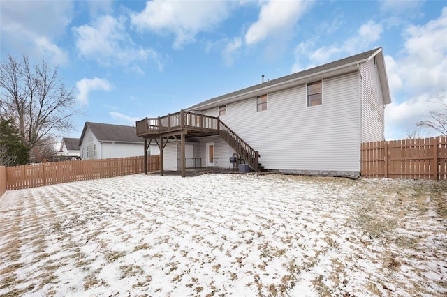 rear view of house featuring a deck, fence private yard, and stairway