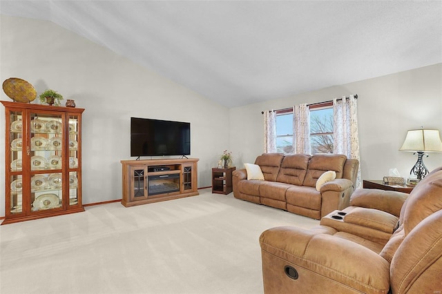 living room with light carpet, vaulted ceiling, and baseboards