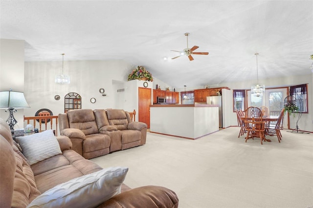 living room with lofted ceiling, ceiling fan with notable chandelier, and light colored carpet