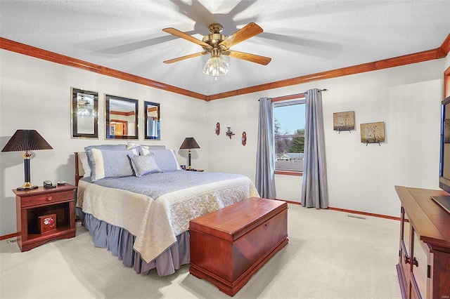 bedroom with ceiling fan, a textured ceiling, light carpet, baseboards, and crown molding