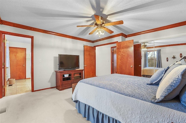 carpeted bedroom featuring a ceiling fan, crown molding, a textured ceiling, and baseboards