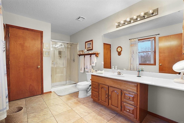 bathroom with a textured ceiling, toilet, vanity, visible vents, and a shower stall