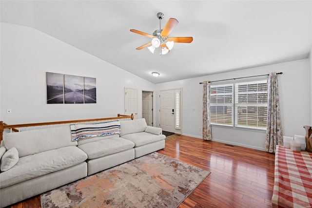 living area with lofted ceiling, ceiling fan, wood finished floors, visible vents, and baseboards