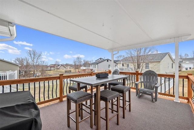 deck with outdoor dining area, area for grilling, and a residential view