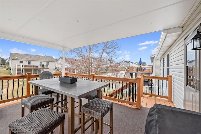 deck featuring outdoor dining space and grilling area