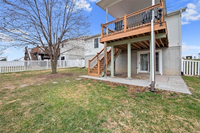 back of property with a yard, a patio, stairway, a deck, and a fenced backyard