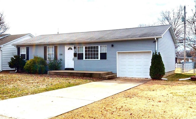 ranch-style home featuring a garage and driveway