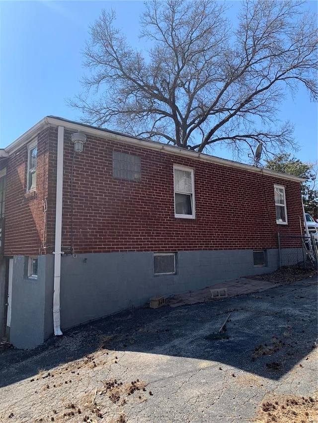 view of property exterior featuring brick siding