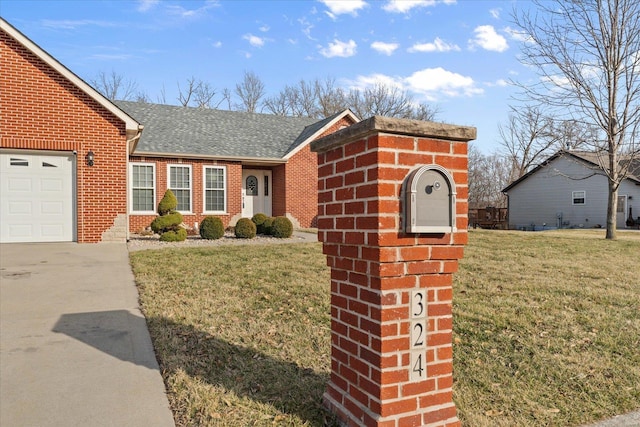 ranch-style home with an attached garage, a shingled roof, a front lawn, and brick siding