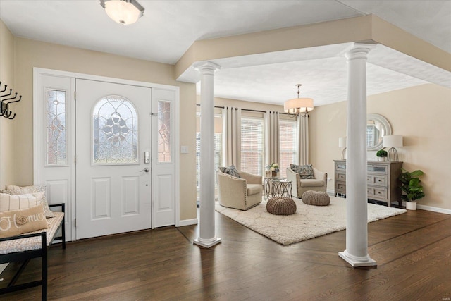 entryway with decorative columns, baseboards, and dark wood-style flooring