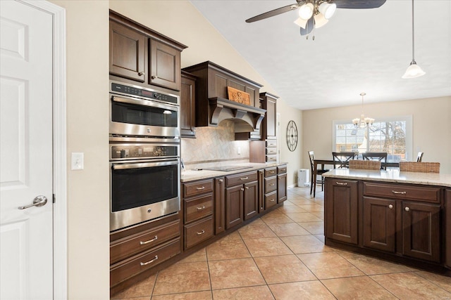 kitchen featuring pendant lighting, backsplash, stainless steel double oven, light tile patterned flooring, and dark brown cabinetry